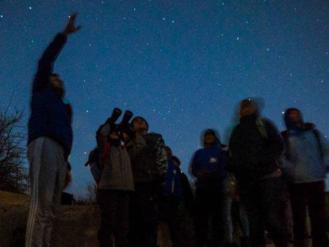 Group looks at night sky during Pali Institute astronomy class