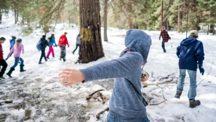 Pali orienteering class walks through snowy woods